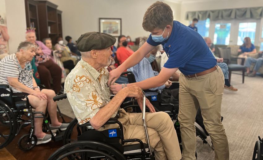 William Evans receives a pin for his service