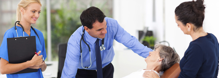 Healthcare professional consoling patient who is lying down